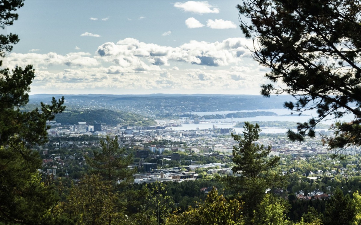 Hiker on boulder with lake and mountain views